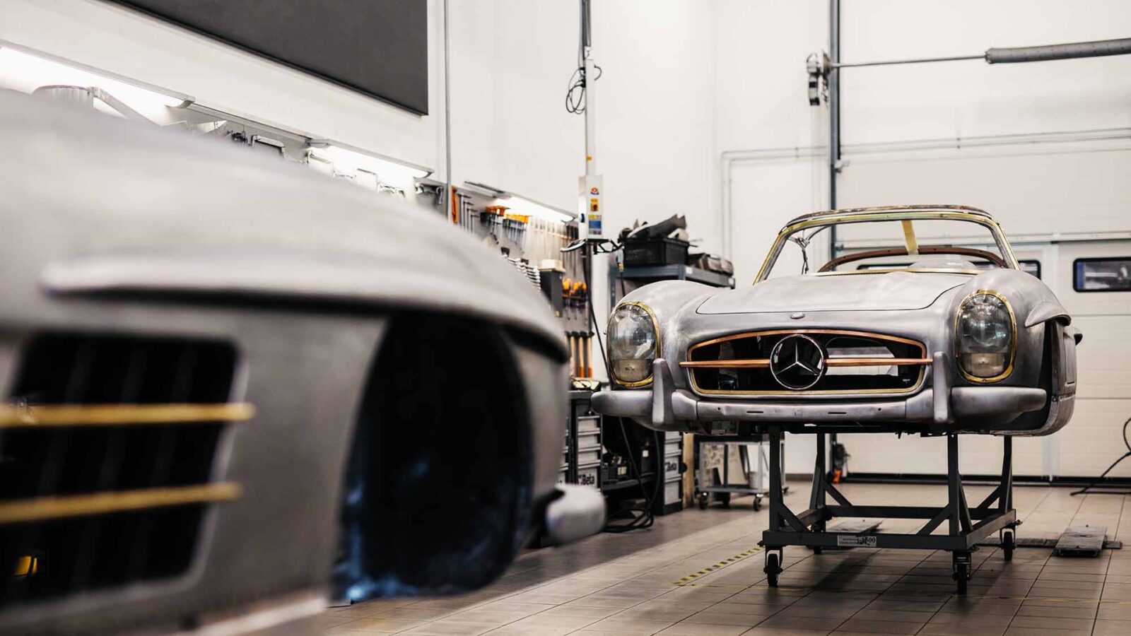 Two bare-metal Mercedes-Benz 300 SL bodies in the Motor Classic workshop in Tatabánya